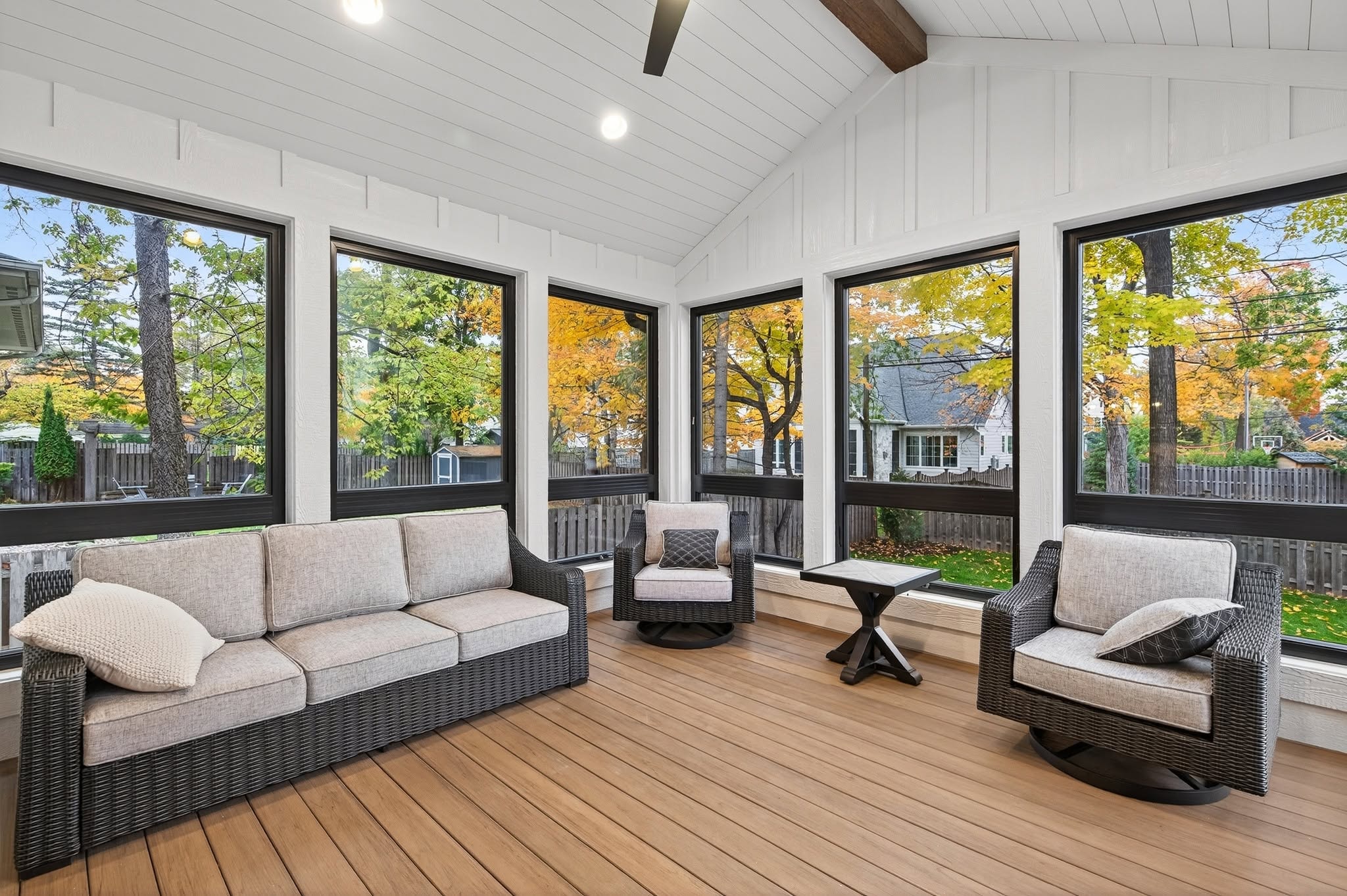 Screened porch with wicker seating and fall views